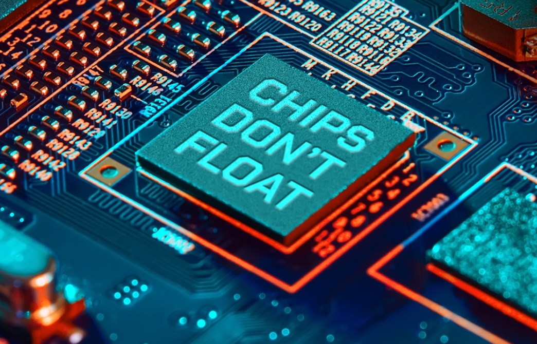 Close-up of a computer circuitboard featuring a prominent microchip in the center labeled CHIPS DONT FLOAT. The surrounding circuitry glows with blue and orange lighting, highlighting the innovation in American Microelectronics.