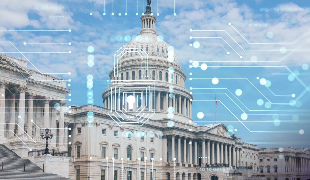 The image shows the U.S. Capitol building with a graphic overlay of digital circuit patterns and a shield symbol, symbolizing cybersecurity or governmental digital protection. The sky is clear with sparse clouds.