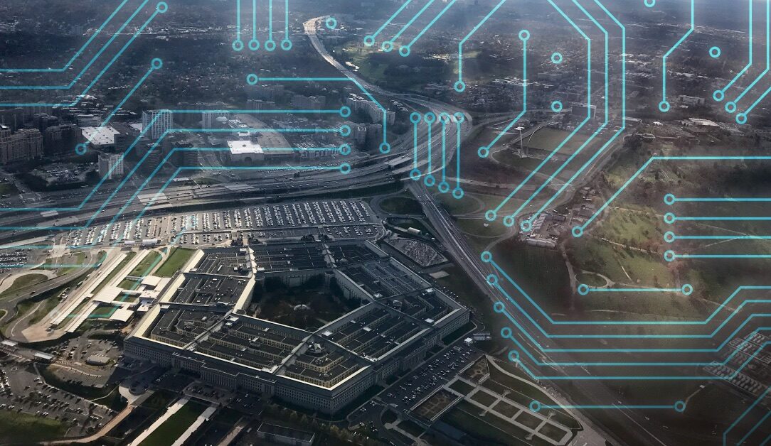 Aerial view of the Pentagon with superimposed blue circuit patterns overlaying the image. The surrounding area features highways and greenery, suggesting a connection between technology and defense infrastructure.